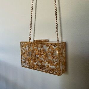 Transparent sling bag with gold detailing